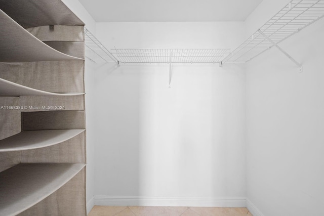 walk in closet featuring tile patterned flooring