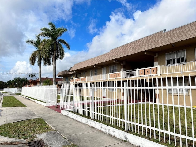 exterior space featuring a yard and a balcony