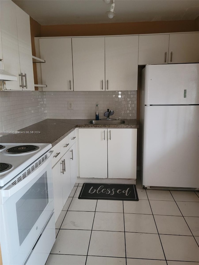 kitchen featuring backsplash, white cabinets, white appliances, and sink