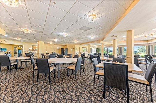 dining room with carpet flooring and a drop ceiling