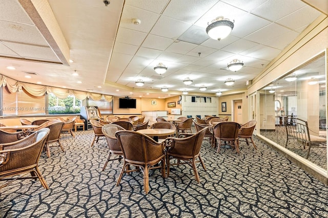 dining room featuring carpet and a raised ceiling