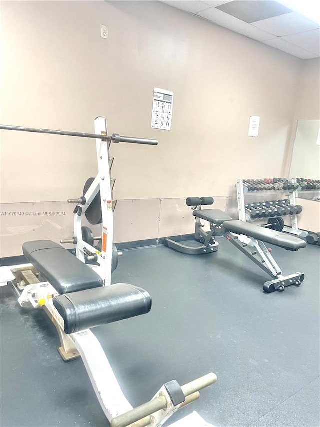 workout area featuring a drop ceiling