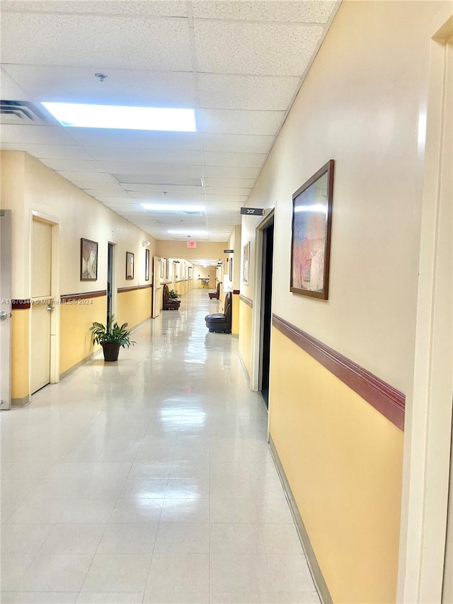 hallway with a drop ceiling