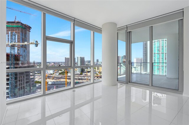 851 NE 1st Ave Unit 2200, Miami, FL 33132 - unfurnished room with floor to ceiling windows, a city view, and tile patterned flooring