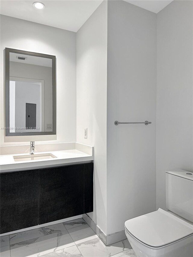 851 NE 1st Ave Unit 2200, Miami, FL 33132 - bathroom with marble finish floors, toilet, baseboards, recessed lighting, and vanity