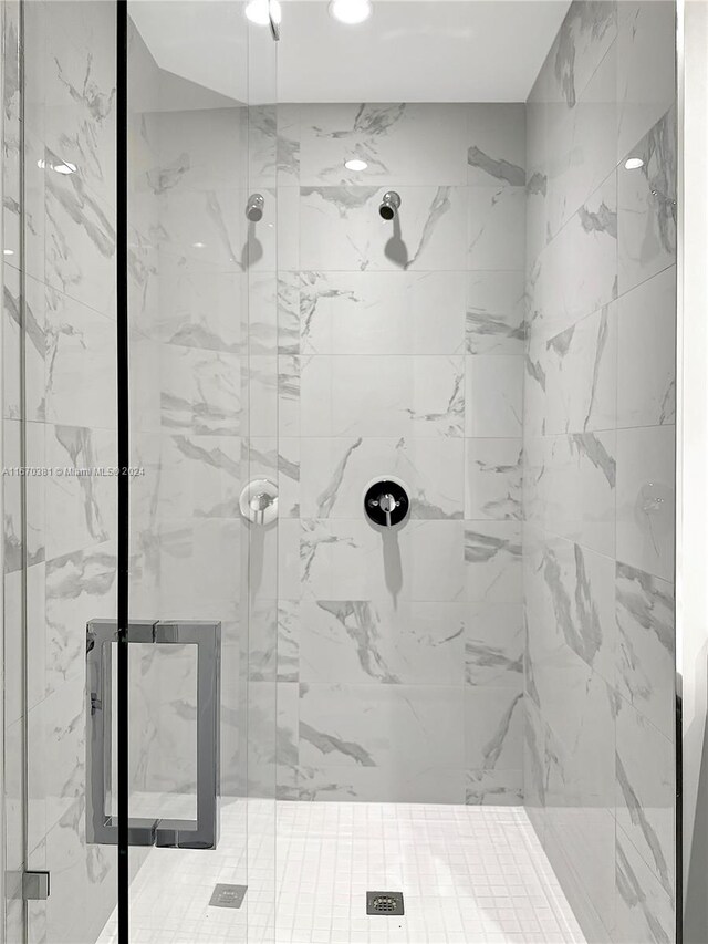 bathroom with a shower with door