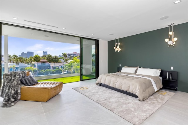 bedroom featuring expansive windows, a chandelier, and access to exterior