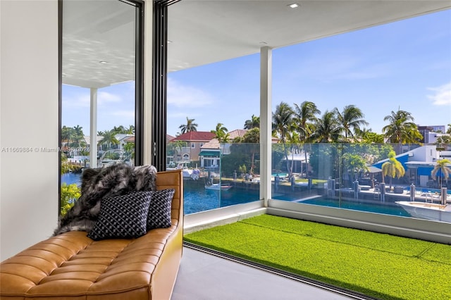 sunroom featuring a water view