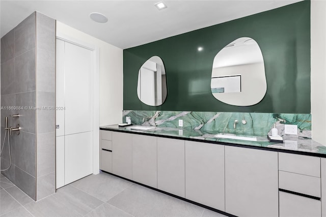 bathroom with vanity, a shower, tile patterned flooring, and tasteful backsplash