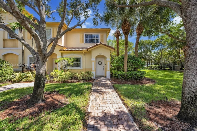 mediterranean / spanish-style house with a front lawn