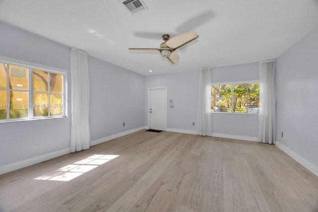 spare room featuring light wood-type flooring and ceiling fan