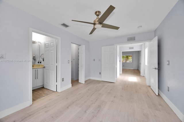 unfurnished bedroom with sink, ceiling fan, ensuite bathroom, and light hardwood / wood-style flooring