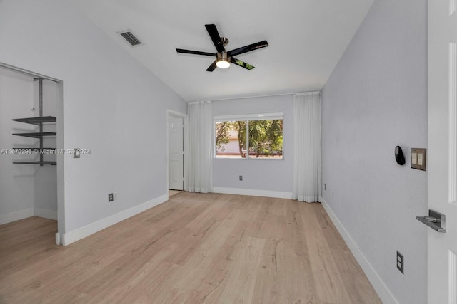 empty room featuring lofted ceiling, ceiling fan, and light hardwood / wood-style flooring