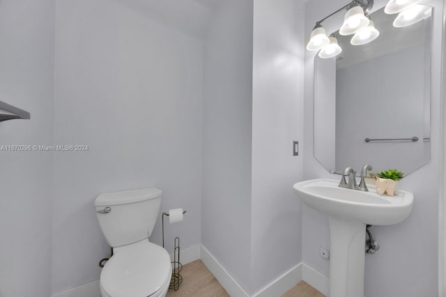 bathroom featuring hardwood / wood-style floors and toilet