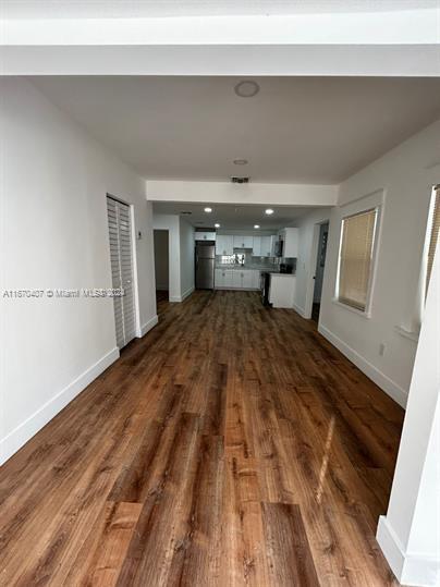 unfurnished living room with dark hardwood / wood-style floors