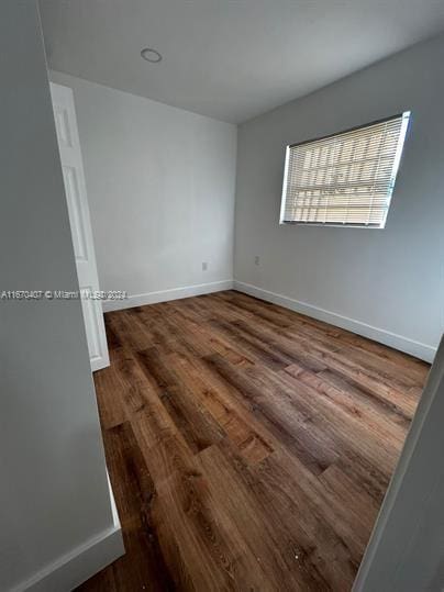 empty room featuring dark hardwood / wood-style floors