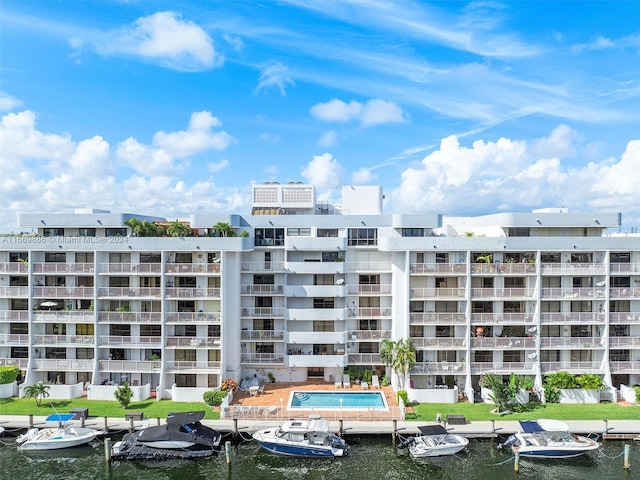 view of property with a water view and a community pool