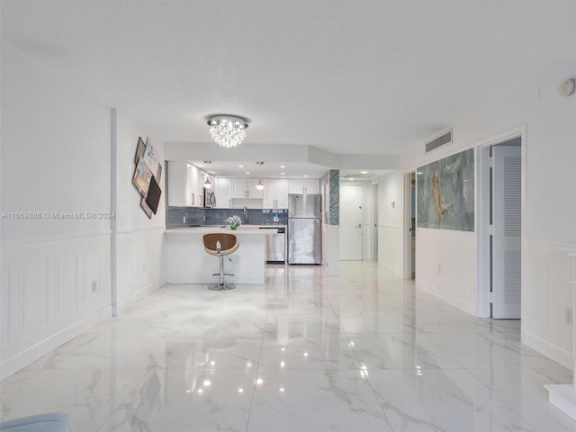 unfurnished living room with a chandelier