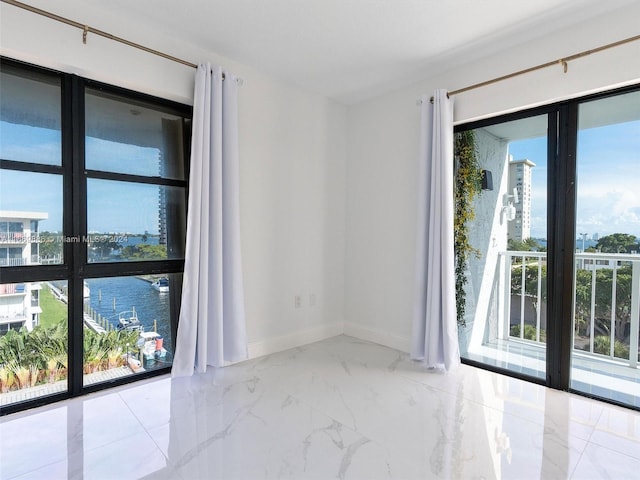 empty room with a water view and plenty of natural light