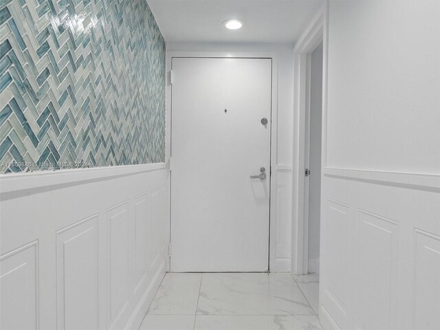 entryway featuring tile walls