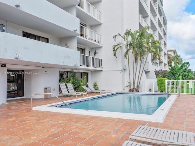 view of swimming pool with a patio