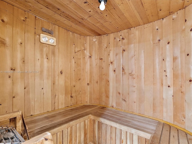 view of sauna with wood-type flooring, wood walls, and wooden ceiling