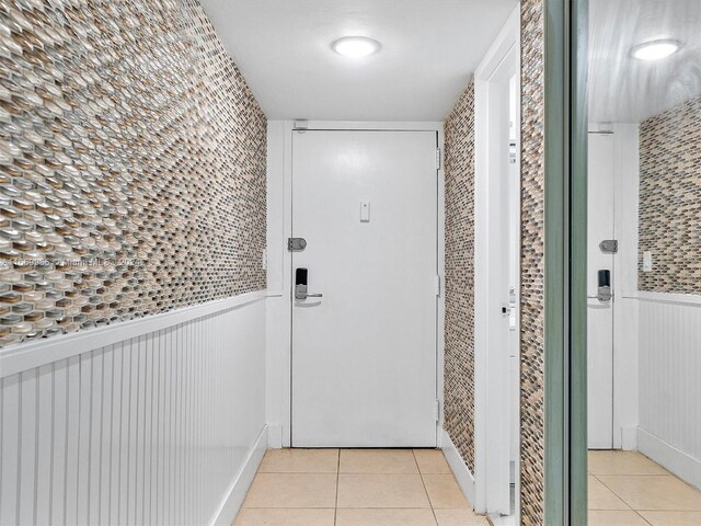 doorway with light tile patterned flooring