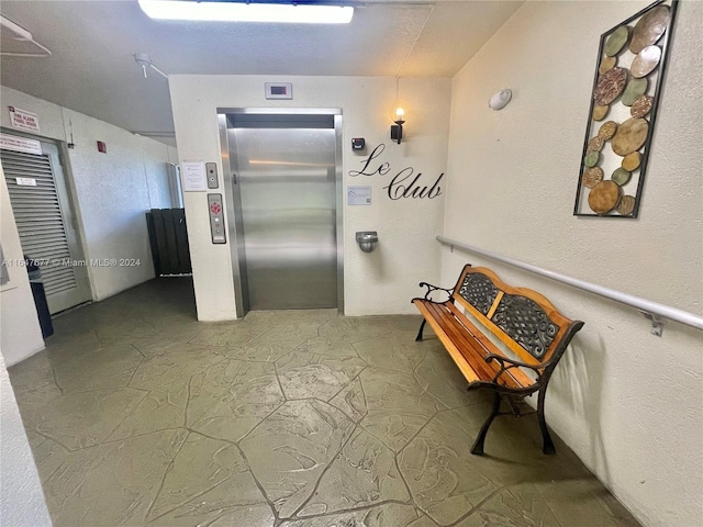 hallway featuring elevator