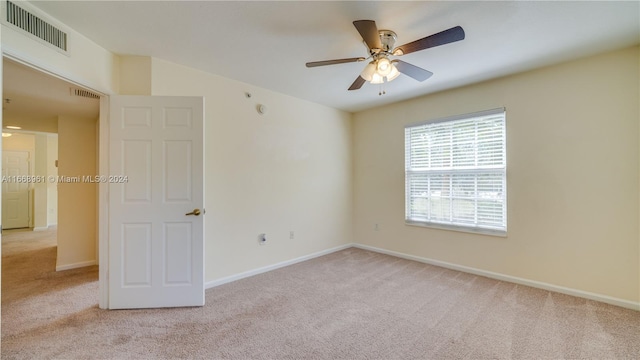 unfurnished room featuring ceiling fan and light colored carpet