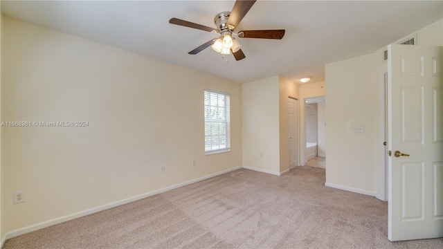 unfurnished room with ceiling fan and light colored carpet