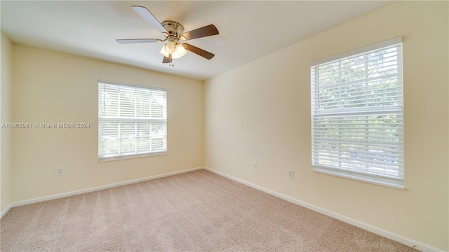 empty room with ceiling fan and light colored carpet