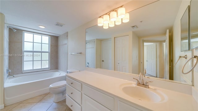 full bathroom with tiled shower / bath, vanity, toilet, and tile patterned floors