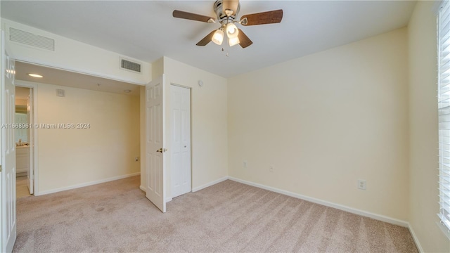 unfurnished bedroom with light carpet and ceiling fan