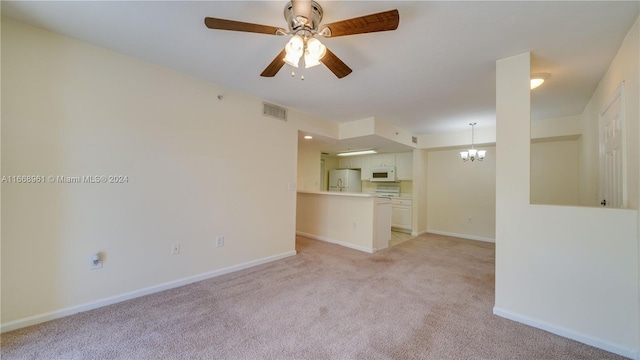 unfurnished living room with light carpet and ceiling fan with notable chandelier