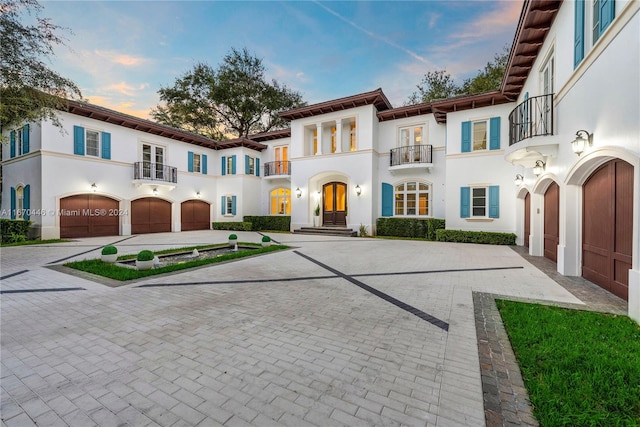 view of front of home featuring a balcony and a garage