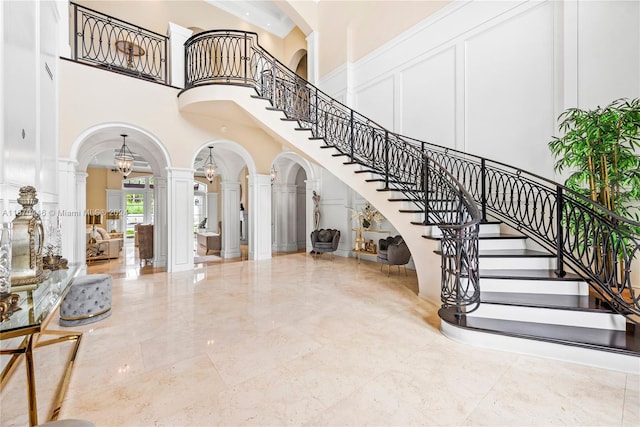 interior space featuring ornate columns and a high ceiling