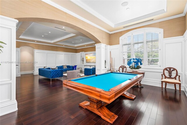 recreation room featuring a raised ceiling, dark hardwood / wood-style flooring, ornate columns, crown molding, and pool table