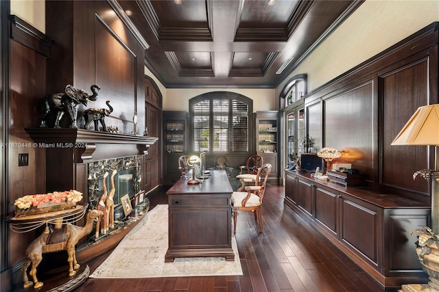 office featuring ornamental molding, a high end fireplace, coffered ceiling, and dark hardwood / wood-style floors