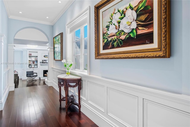 corridor with crown molding and dark wood-type flooring