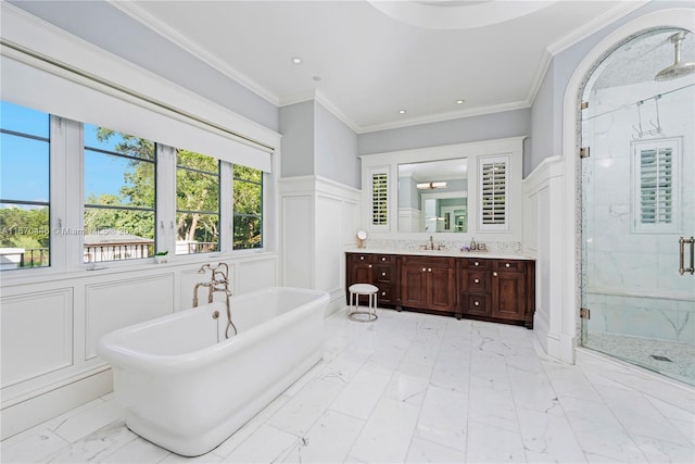 bathroom with plus walk in shower, ornamental molding, and vanity