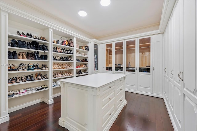 walk in closet with dark wood-type flooring