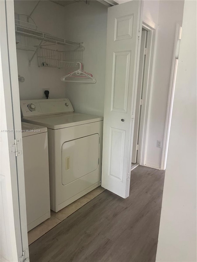 laundry area featuring dark hardwood / wood-style floors and washer and dryer