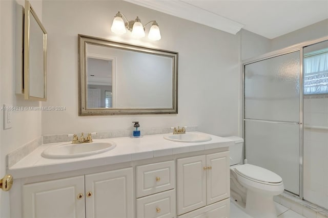 bathroom featuring vanity, walk in shower, crown molding, toilet, and tile patterned floors