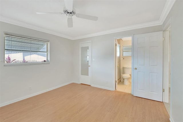 unfurnished bedroom with light wood finished floors, a ceiling fan, crown molding, baseboards, and ensuite bathroom