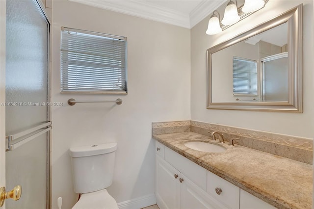 bathroom featuring vanity, a shower with shower door, toilet, and crown molding