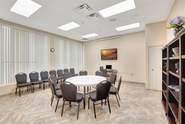 dining room with a drop ceiling