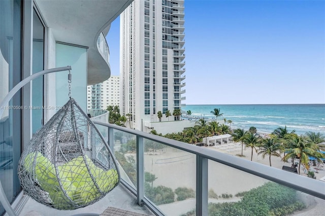 balcony with a view of the beach and a water view