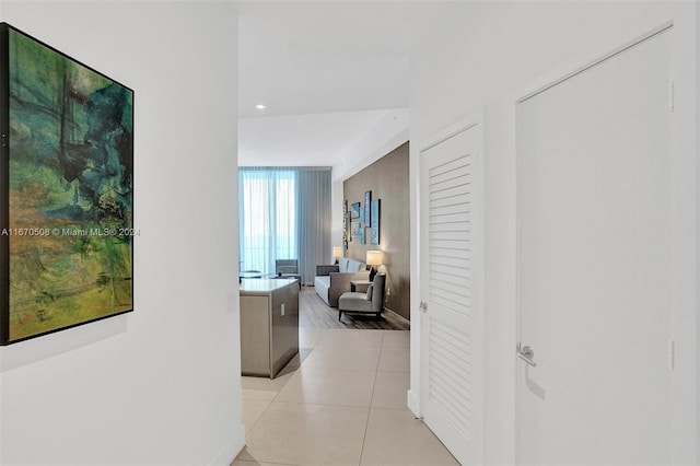 hall featuring light tile patterned flooring