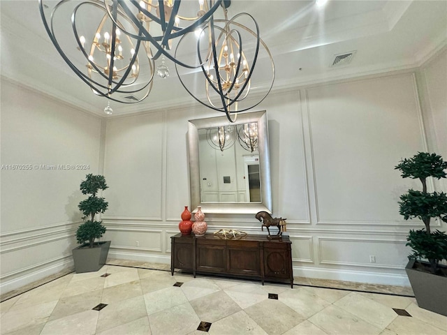 interior details featuring an inviting chandelier and crown molding