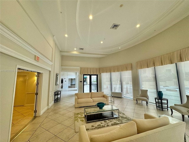 living room with ornamental molding, a towering ceiling, and light tile patterned floors